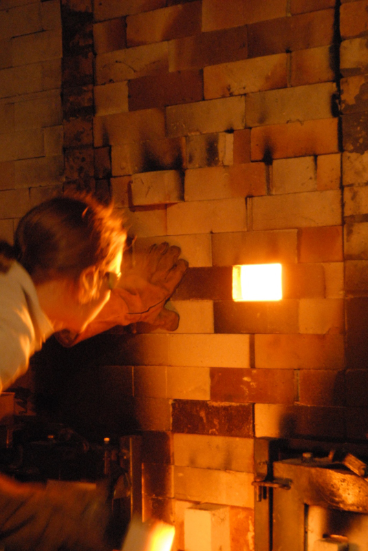 Mandy Parslow, checking the cones during the firing of the wood fired salt glaze kiln in Tipperary.